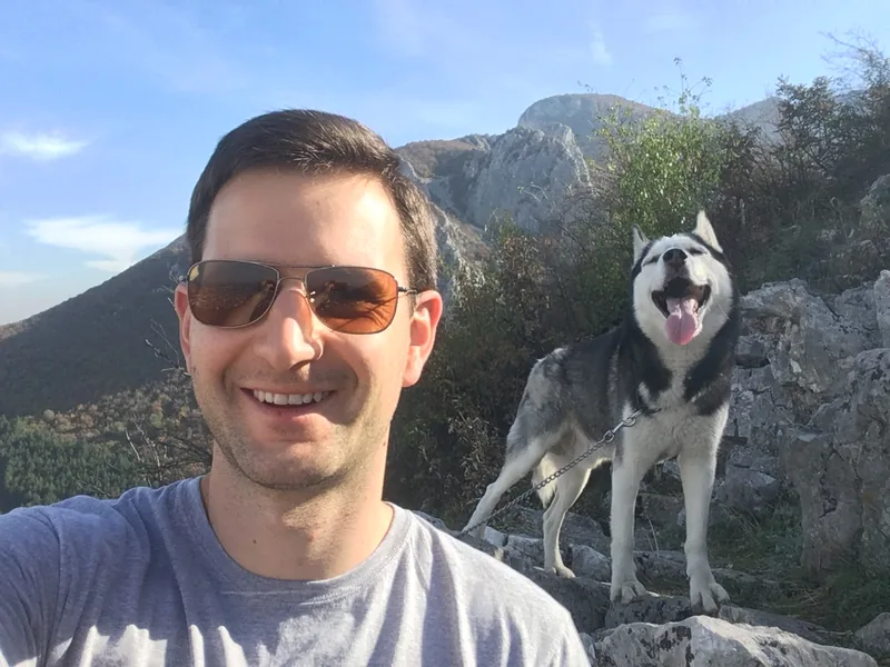 Momchil Kyuparski on a mountain hike with a husky